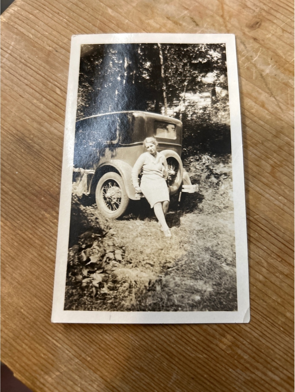Vintage picture of a woman by a car